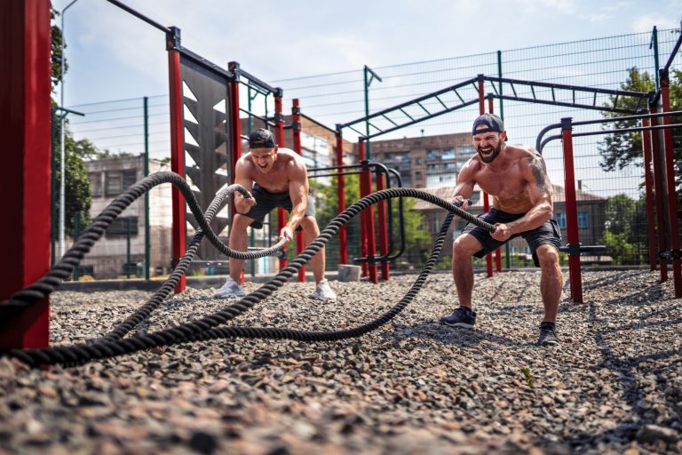 Athletes doing outdoor rope training at a functional fitness gym