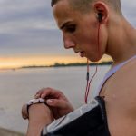 Runner checking a GPS smartwatch on their wrist during an outdoor training session