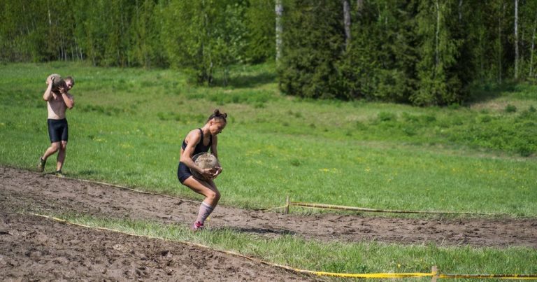Athletes competing in an independent obstacle course race on outdoor terrain