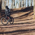 Mountain biker riding trail through a forest — OCR crossover athlete spotlight