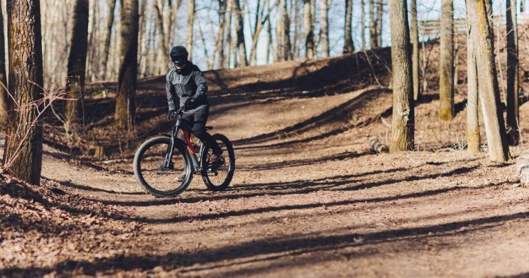 Mountain biker riding trail through a forest — OCR crossover athlete spotlight