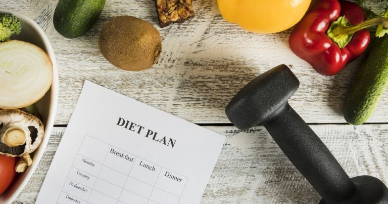 Diet plan with vegetables and dumbbells representing athlete nutritional periodization