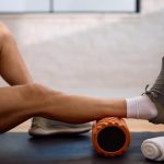 Athlete using a foam roller for muscle recovery