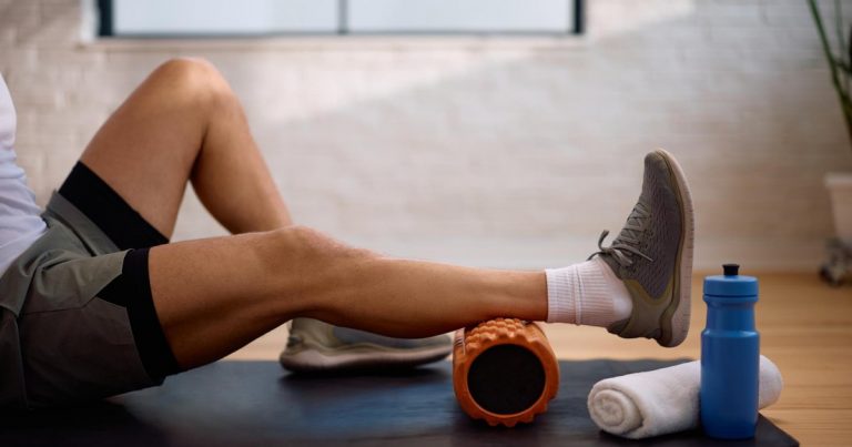 Athlete using a foam roller for muscle recovery