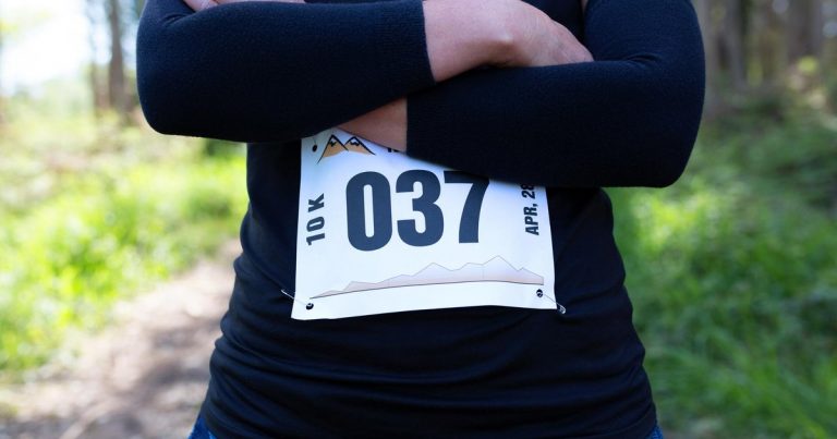 Female trail athlete wearing a race bib number at an OCR event
