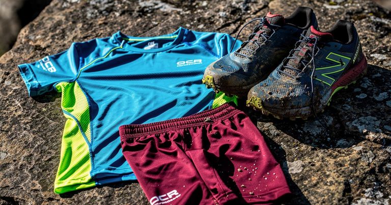OCR technical race-day apparel including shirts and compression shorts on trail terrain