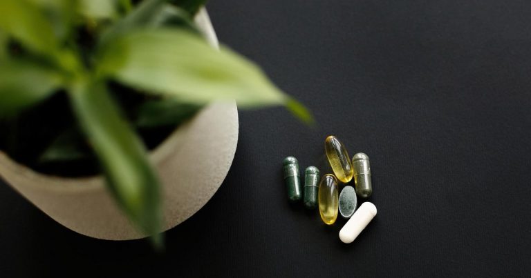 Vitamin D, magnesium, and omega-3 supplements flat lay for OCR athlete recovery