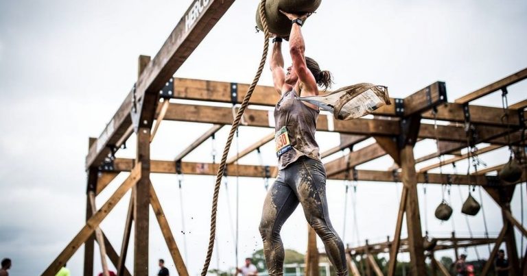 OCR athlete pulling the Hercules Hoist rope obstacle at an obstacle course race