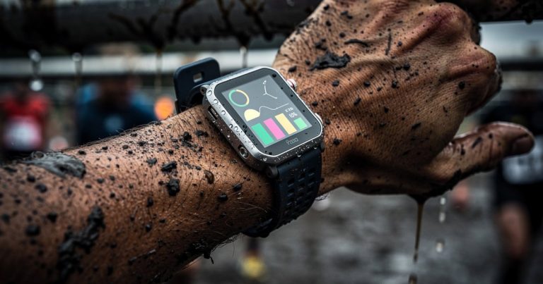 Wearable technology smartwatch on athlete wrist during obstacle course race