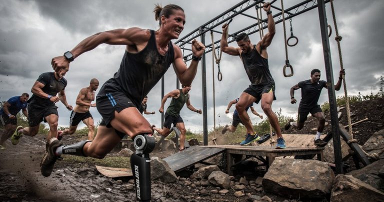 Adaptive and able-bodied athletes competing together on an obstacle course racing course