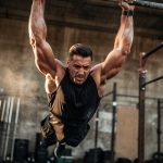 OCR athlete performing a dead hang strength benchmark test outdoors