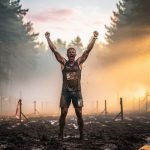 OCR athlete triumphant at finish line at dawn